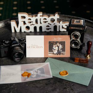 Gutschein Feuerquell mit Kamera und perfect moments Schild